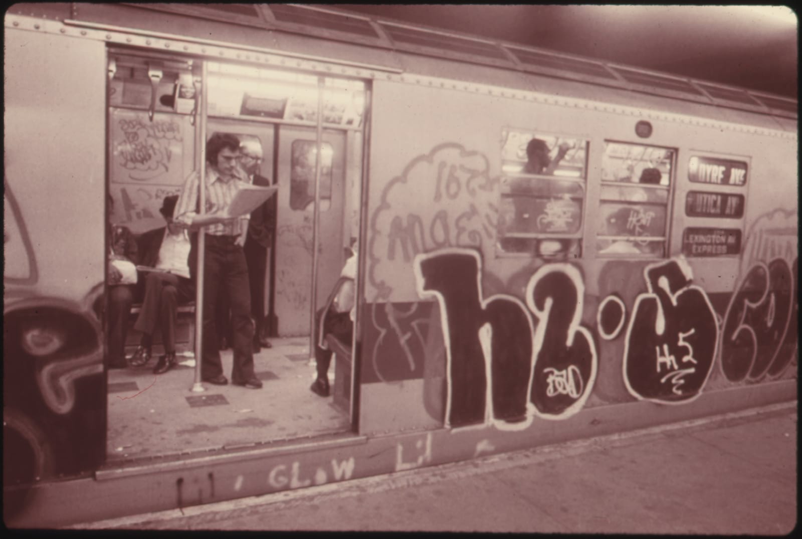 A New York City subway car covered inside and out with spray-painted graffiti, mid-1970s.