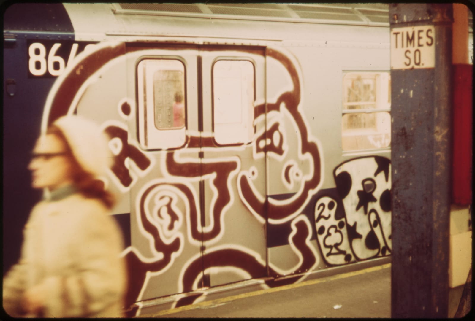 A graffiti-covered subway train and platform at the Times Square station in New York City in the 1970s.
