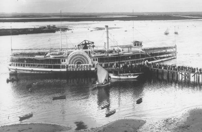 A period photograph of the General Slocum, a large wooden side-wheel paddle steamer, before the fire that killed about 1,021 people.