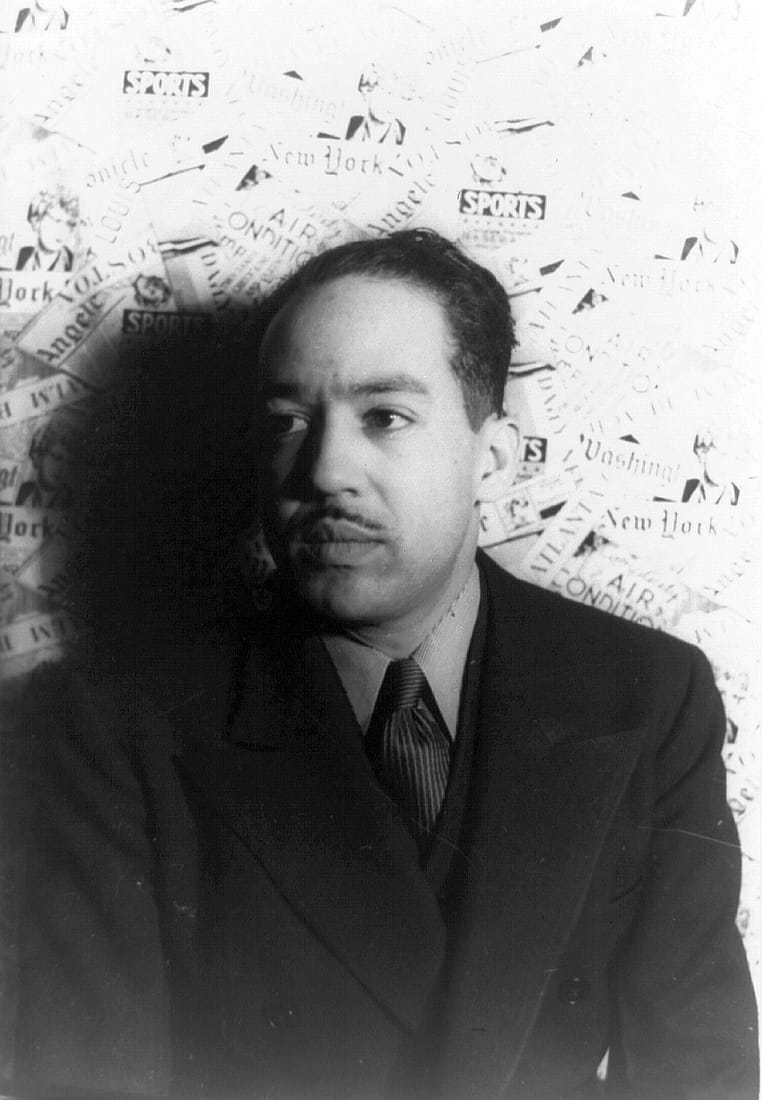 A 1936 black-and-white portrait of the poet Langston Hughes in a suit.