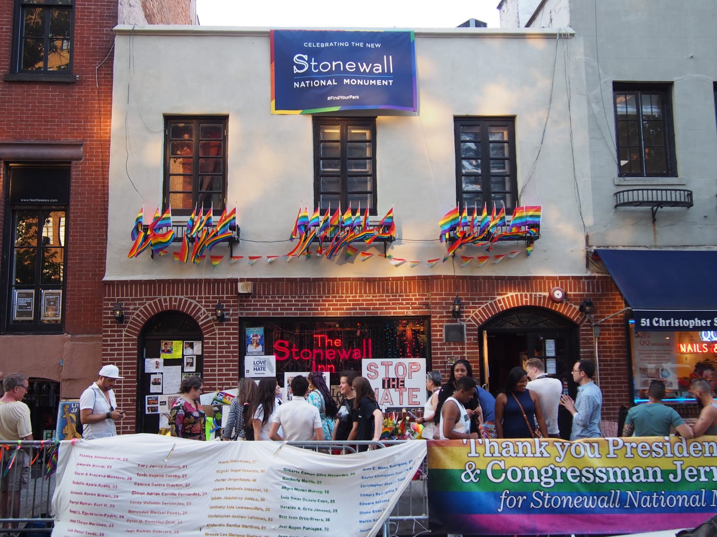 The rainbow-flag-draped facade of the Stonewall Inn on Christopher Street during Pride weekend 2016.