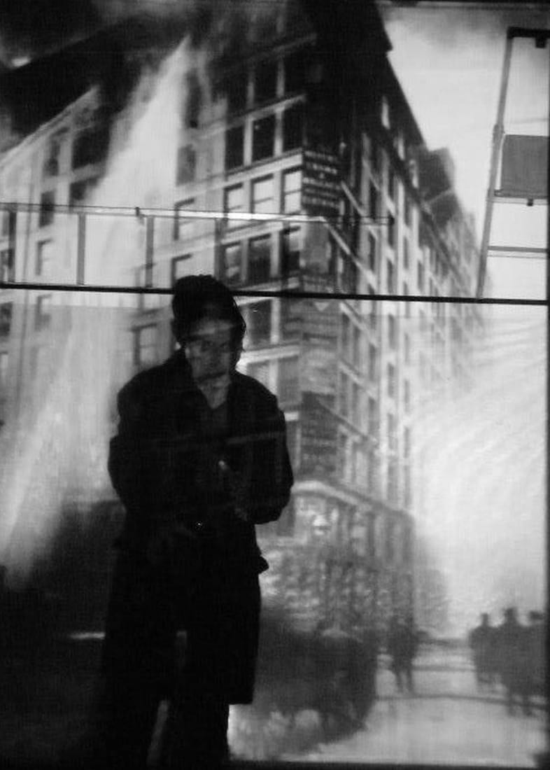 The upper floors of the Asch Building on fire on March 25, 1911, smoke pouring from the windows.